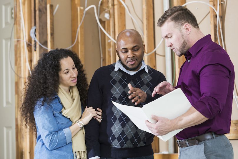 Contractor walking a couple through plans