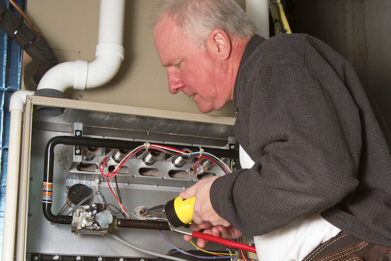 Man troubleshooting a furnace