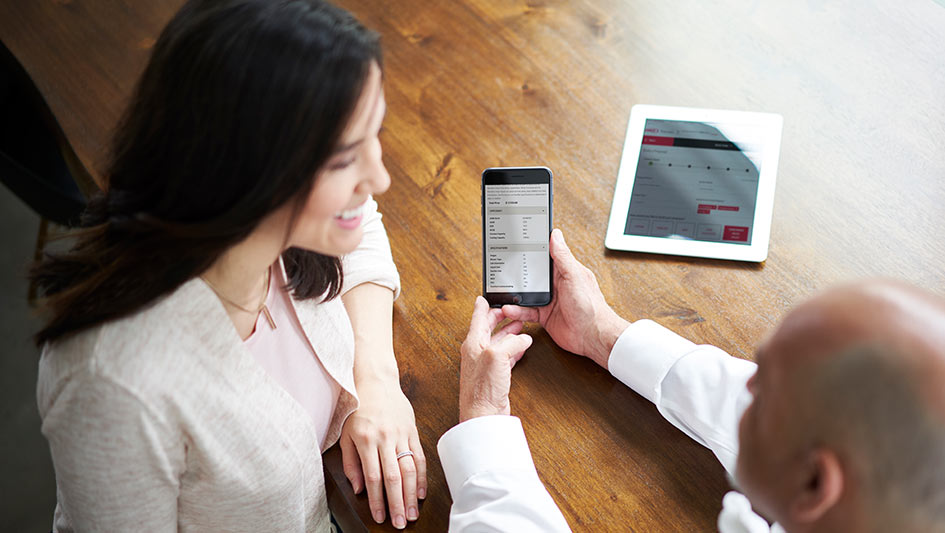 Woman being shown Nest features on a phone