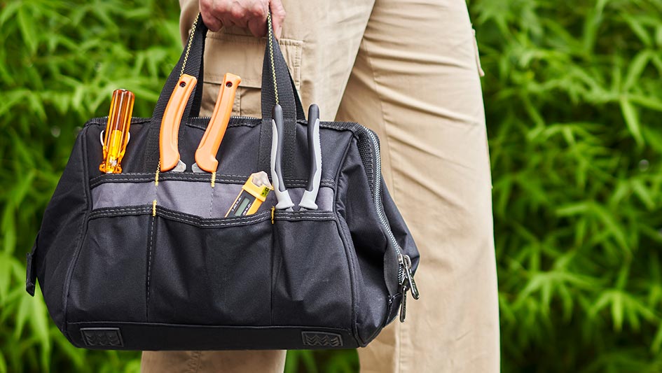 Person carrying a bag of tools