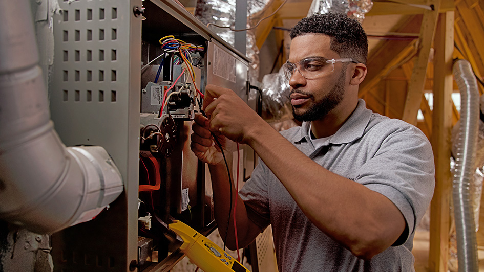 Technician replacing cracked heat exchanger