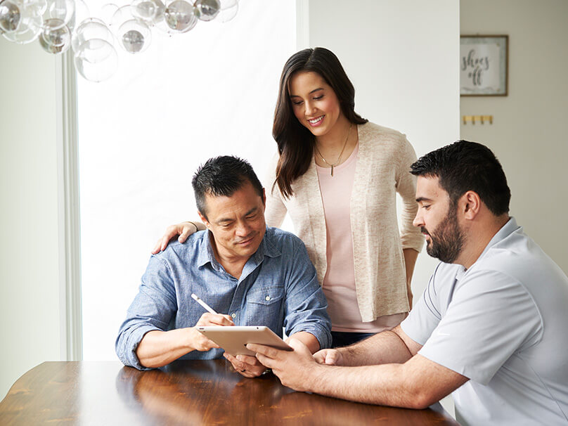 couple consulting with an HVAC technician