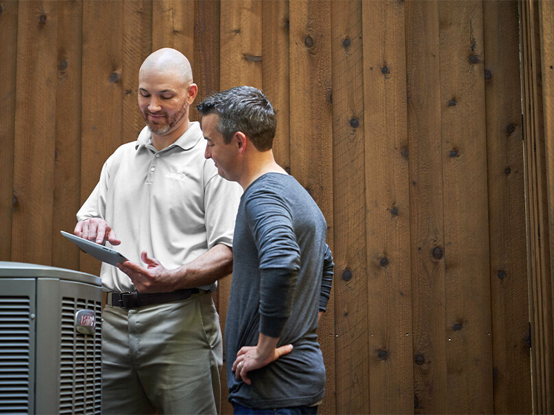 Men looking at information on a new heat pump