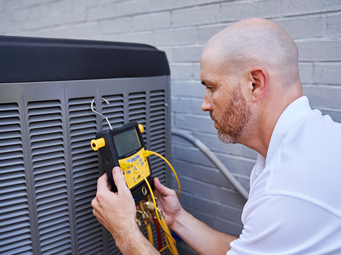 HVAC technician performing maintenance
