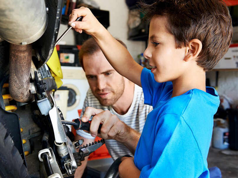 father and son working in the garage