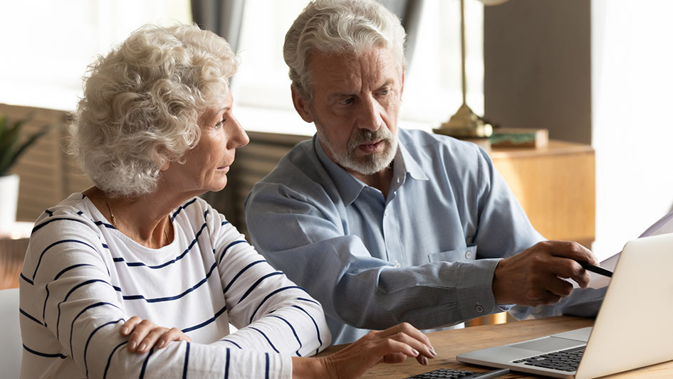 Older couple looking at a laptop