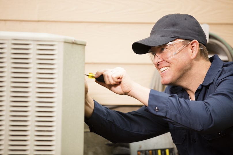 HVAC technician installing an AC unit