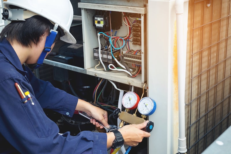 HVAC technician performing AC maintenance