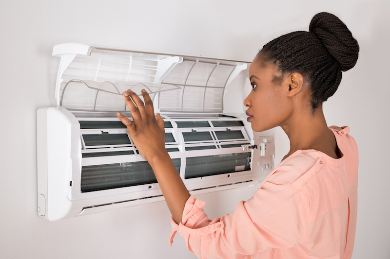Woman Opening Air Conditioner Woman Opening Air Conditioner