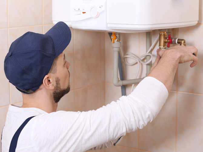 technician installing a water heater