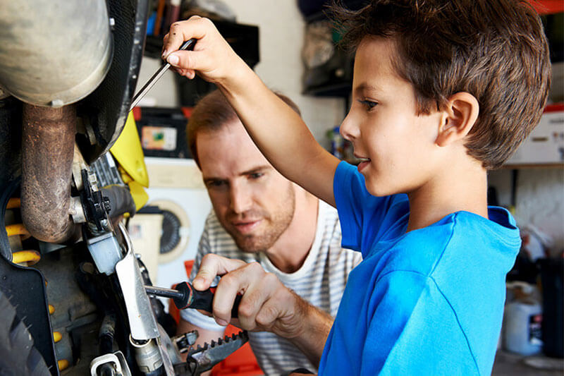 father and son working in the garage