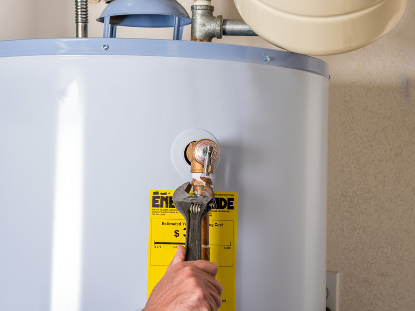 technician performing water heater installation