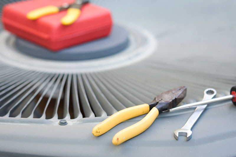 tools sitting on an AC unit