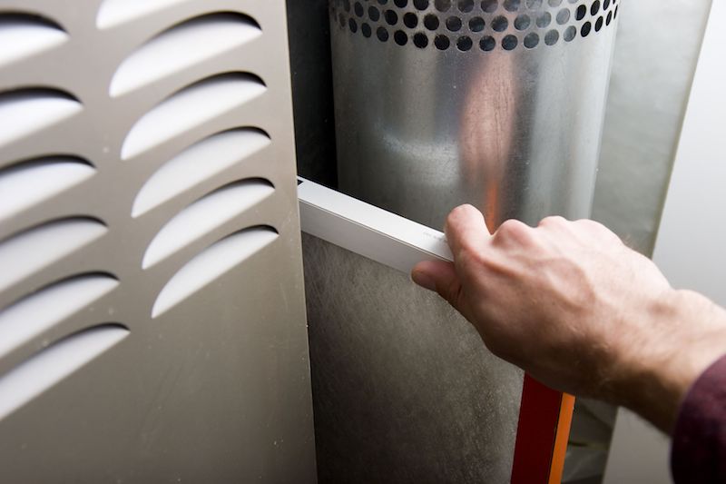 man changing a furnace filter