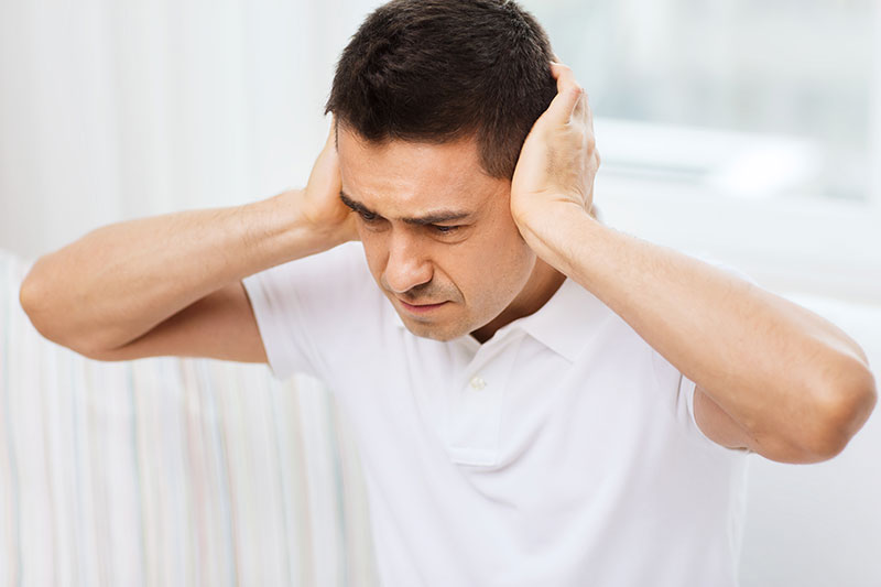 man covering his ears