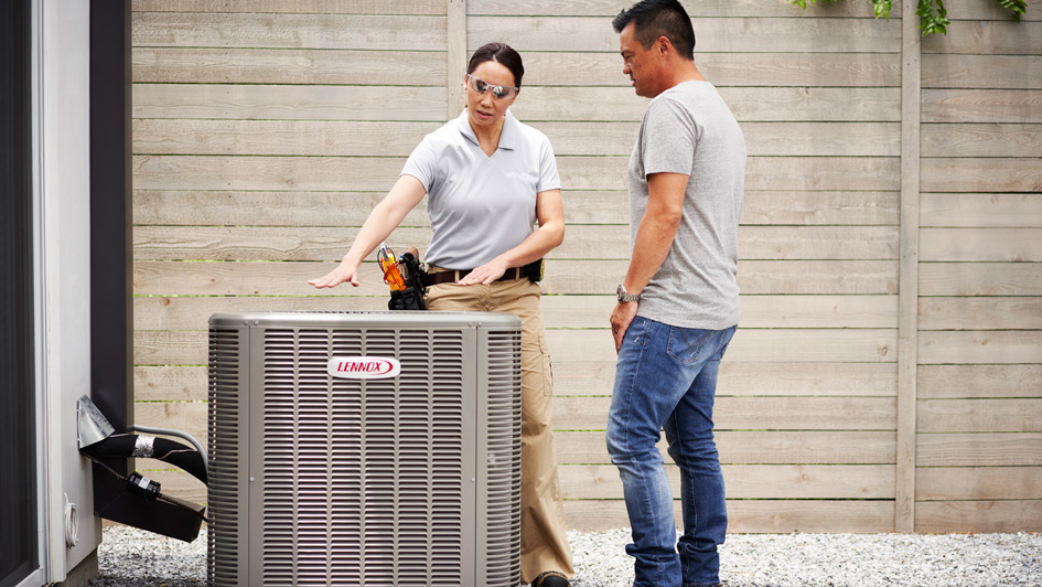 Woman showing a man an air conditioning unit
