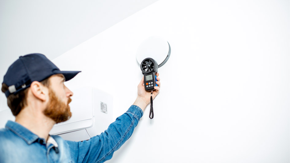HVAC tech performing home energy audit