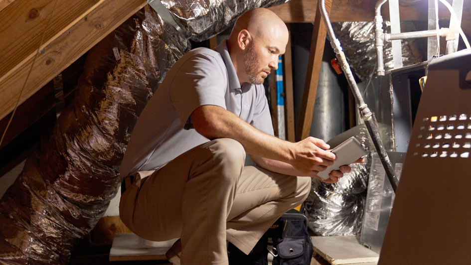 HVAC tech performing furnace maintenance
