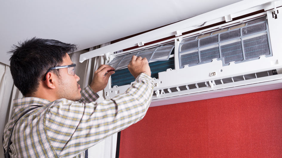 man servicing an HVAC unit