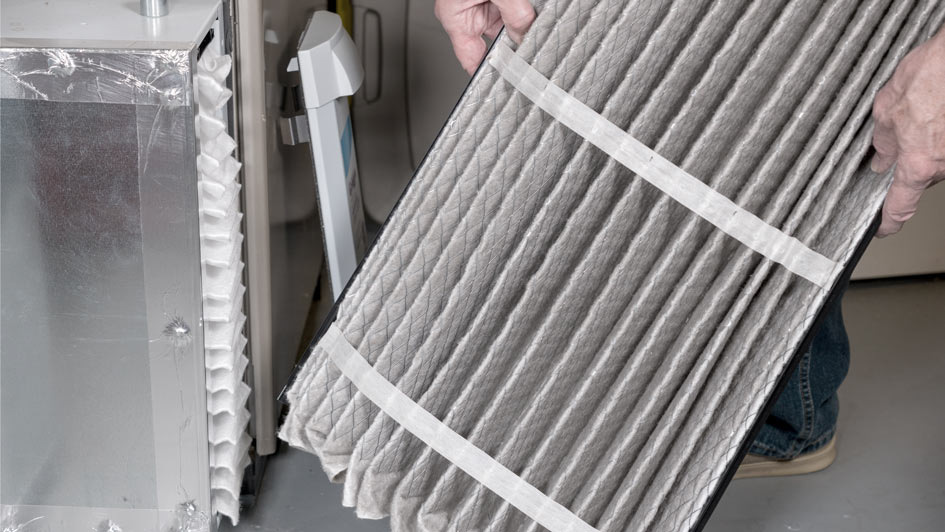 man replacing an HVAC filter