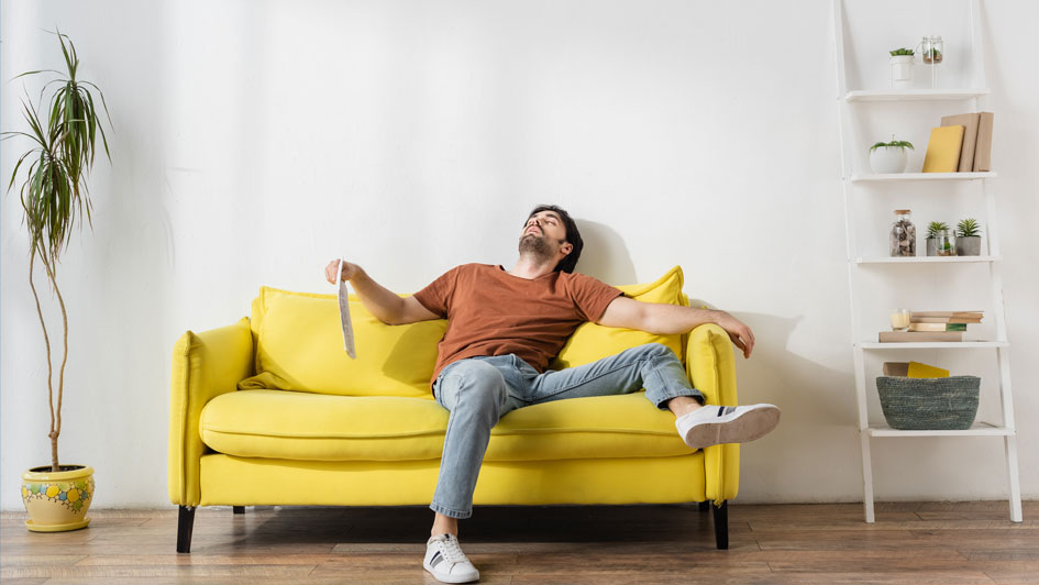 Man sitting on yellow couch