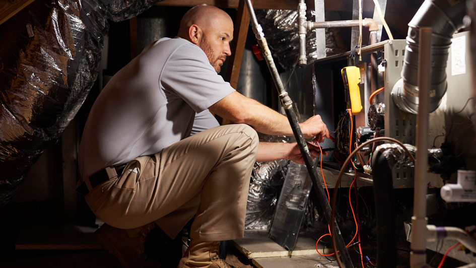 HVAC tech performing furnace maintenance