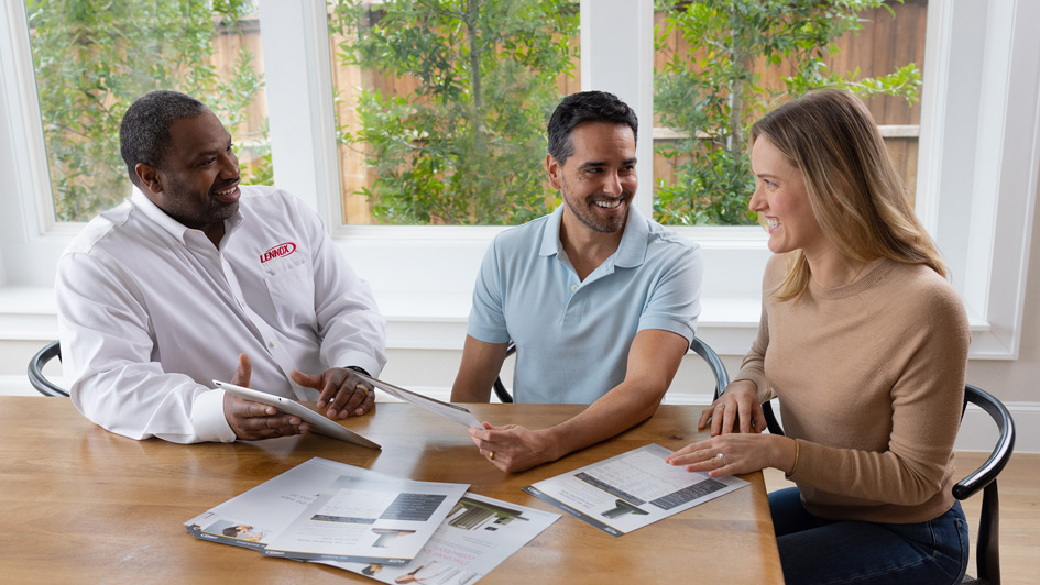 Homeowners talking to Lennox HVAC technician