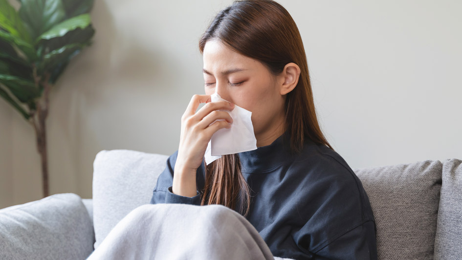 Woman blowing her nose