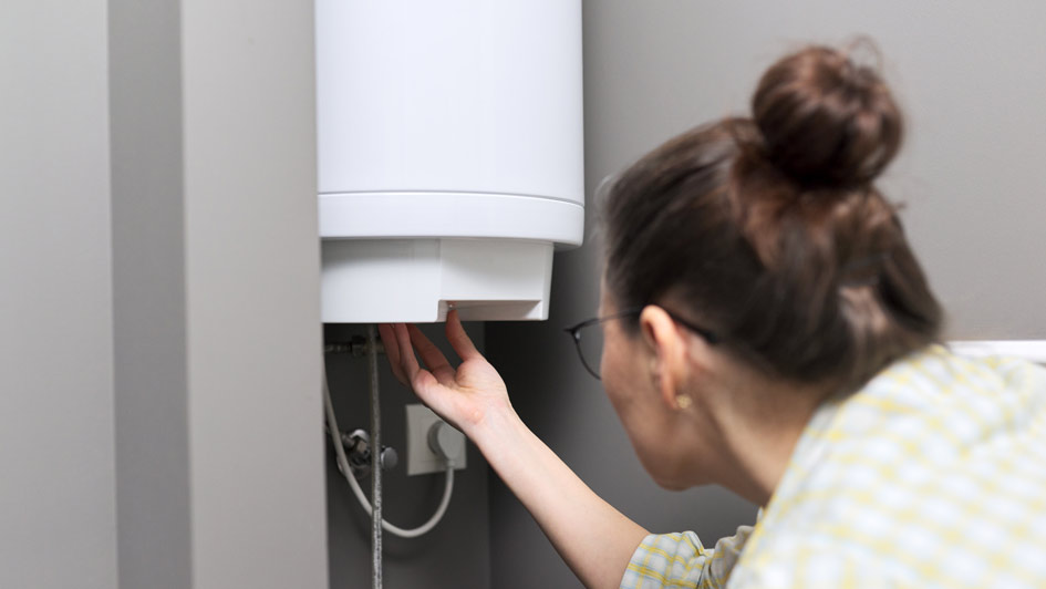 Woman checking water heater