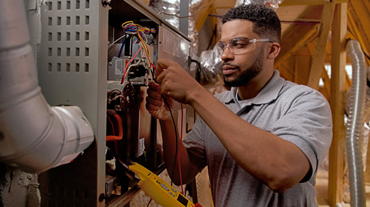 HVAC Technician repairing a furnace unit