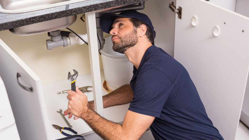 Plumber working on sink
