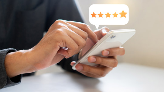 Person leaving 5-star review on phone