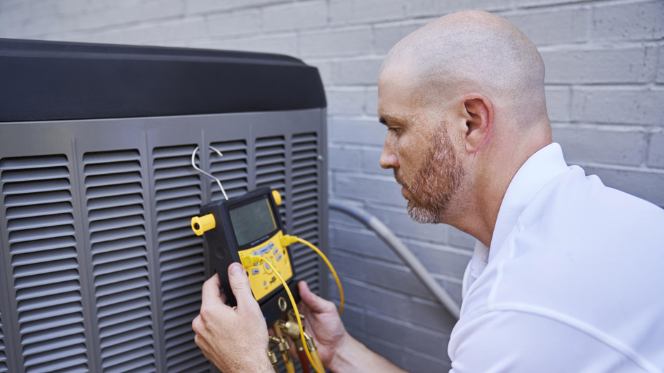 Technician working on AC unit