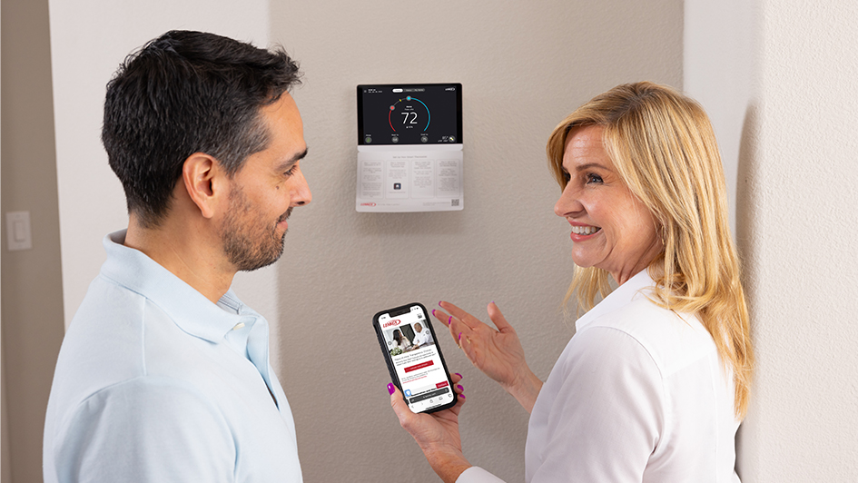 Customer and technician talking about wall thermostat
