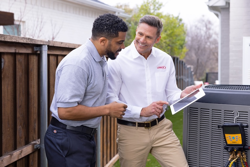 Lennox dealer showing a customer information about his new air conditioner